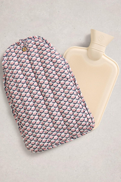 Hot water bottle with a pink and white patterned cover on a light gray background