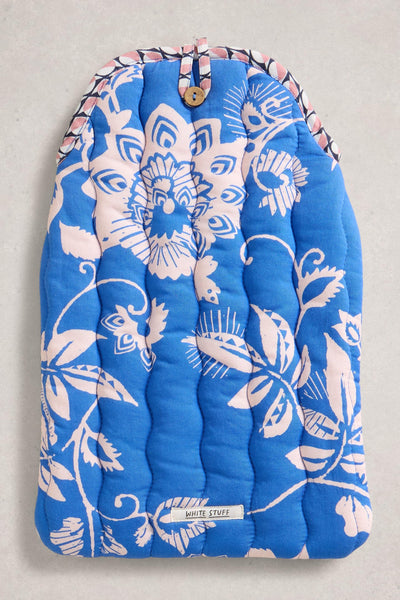 Blue floral-patterned hot water bottle on a light gray background
