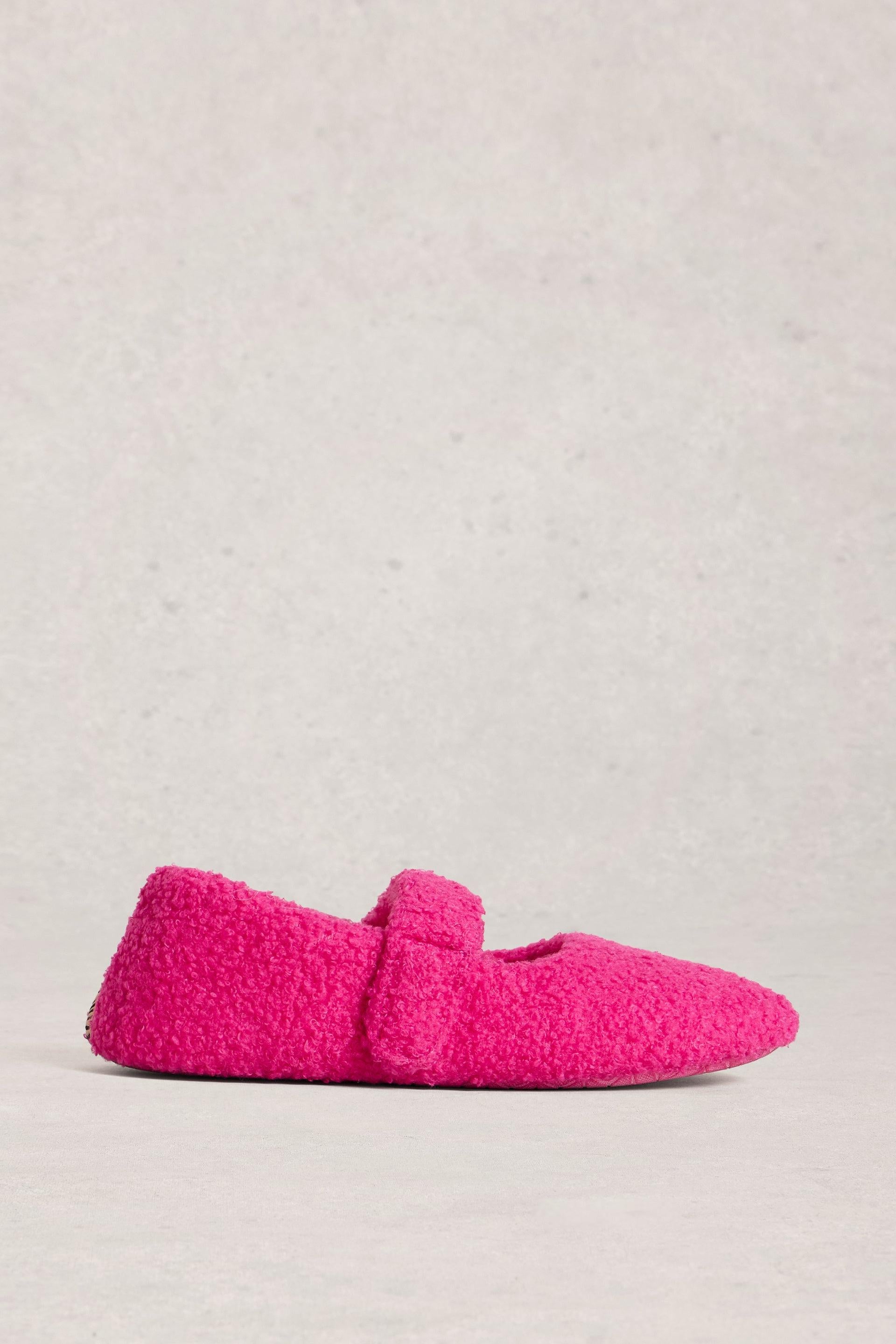 Pink slippers on a light gray background