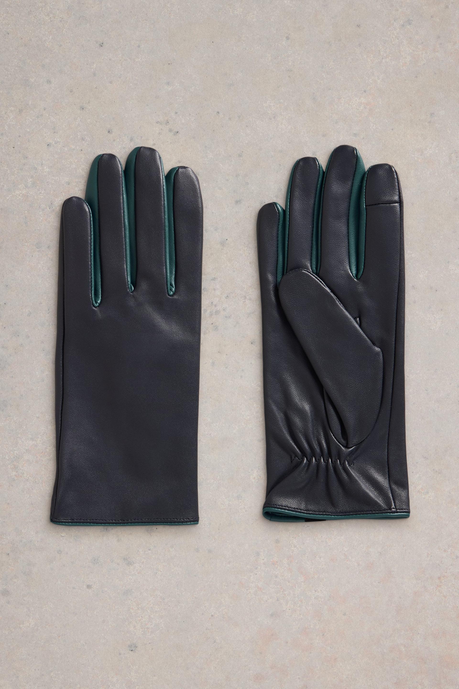 Flat lay of navy leather gloves with turqoise details