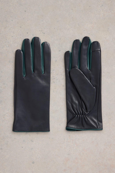 Flat lay of navy leather gloves with turqoise details