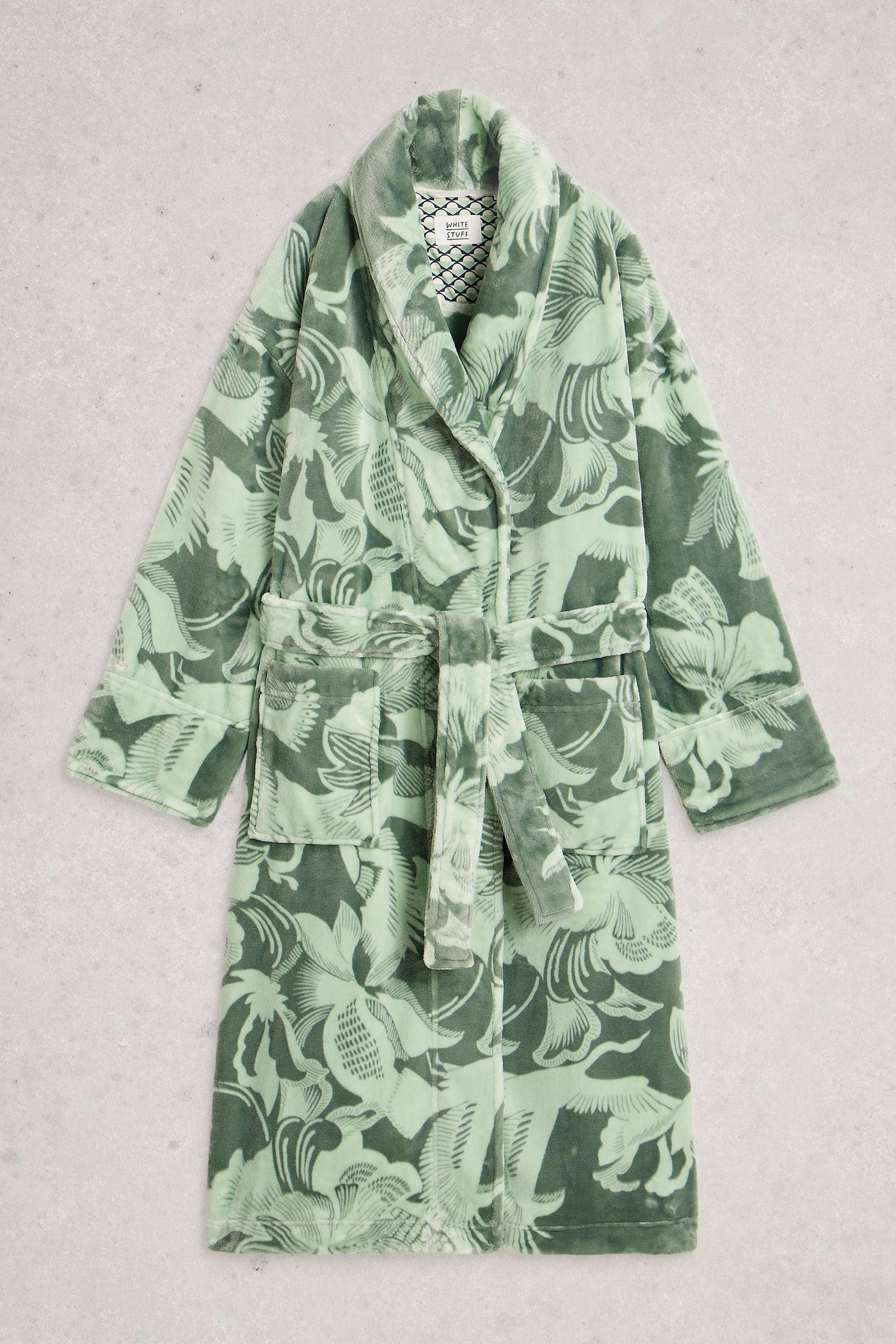 Green robe with floral pattern on a light gray background