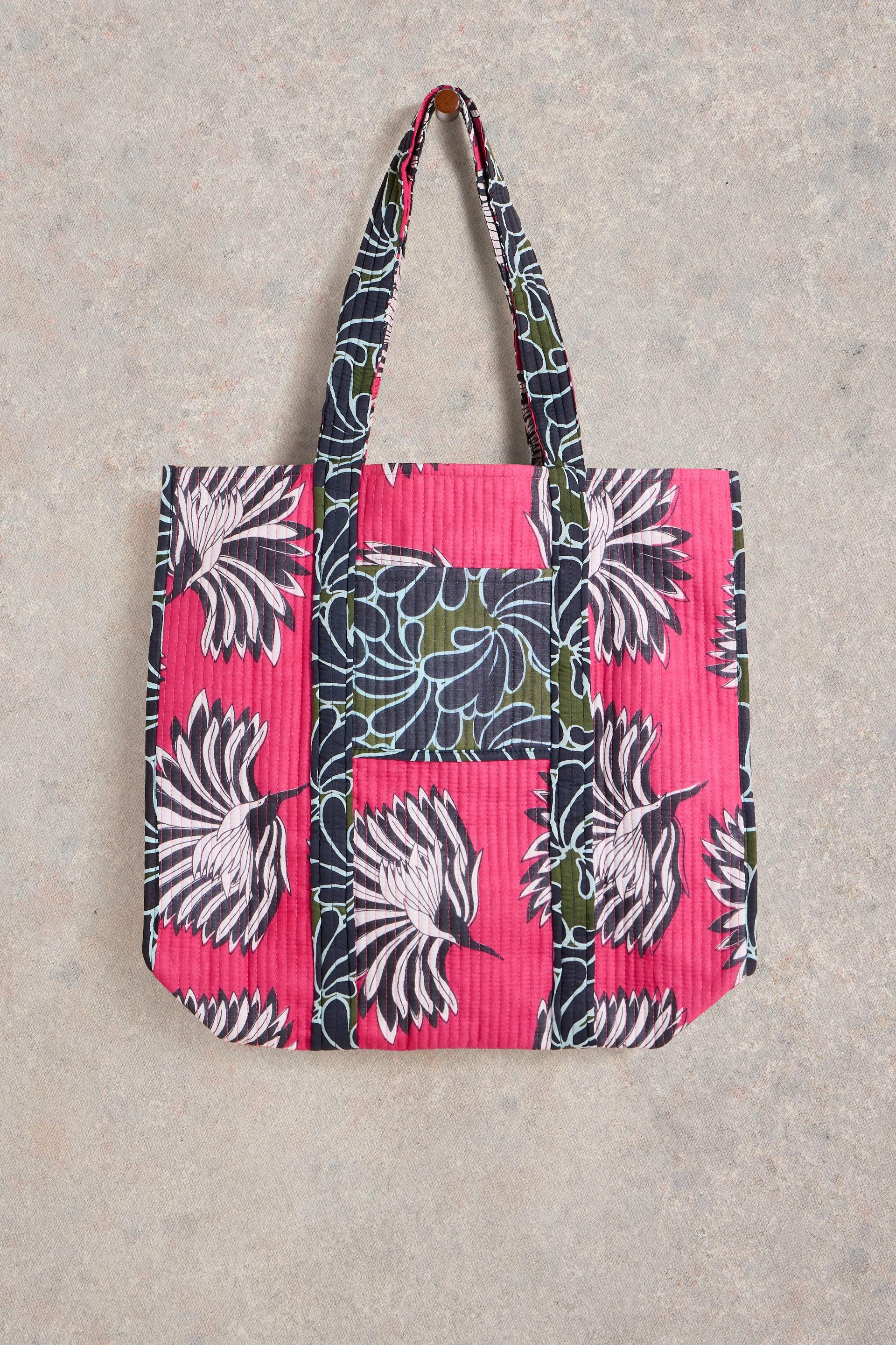Beach bag laid flat on neutral background