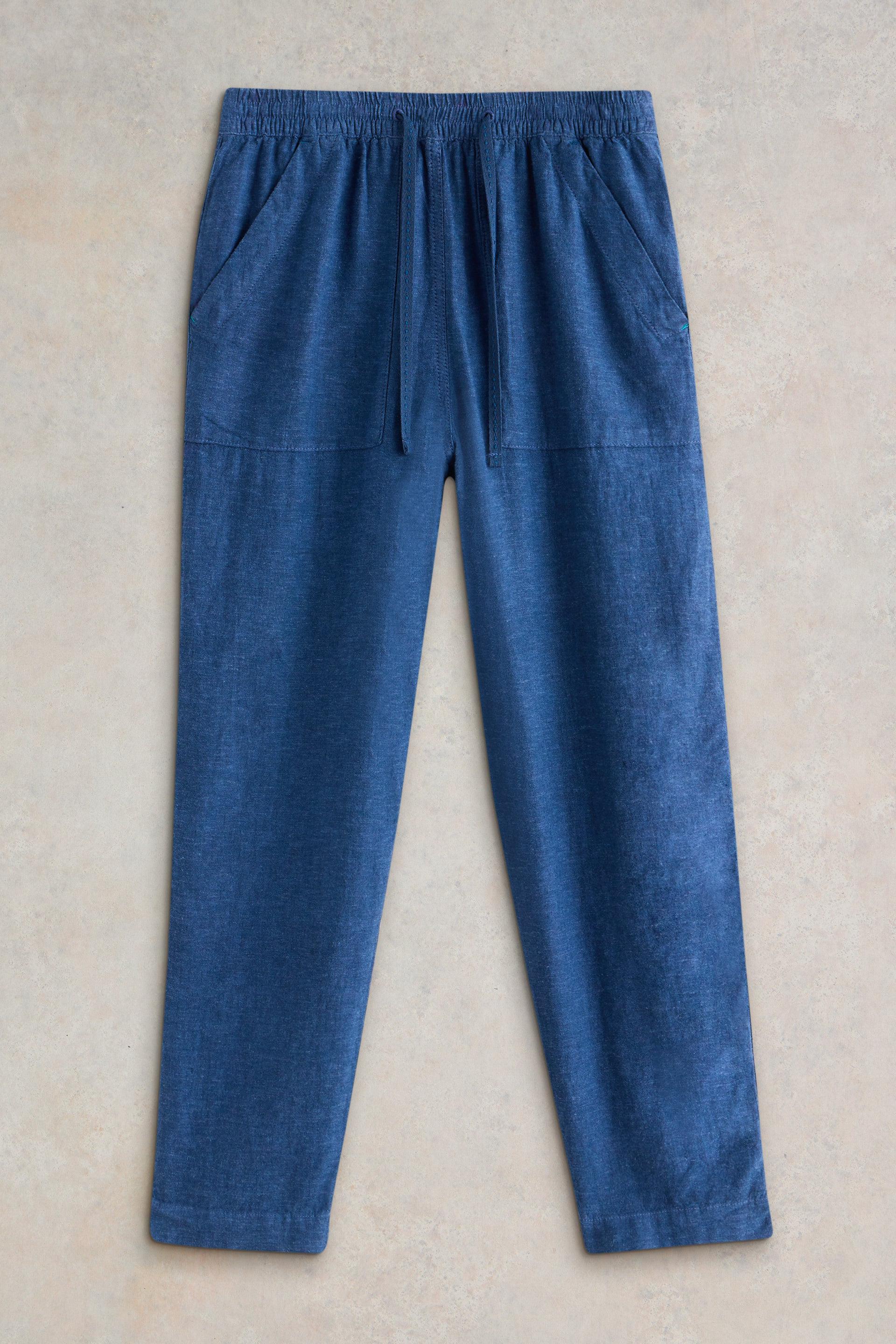 White Stuff Elle Chambray Blue Linen Blend Trousers on grey background.