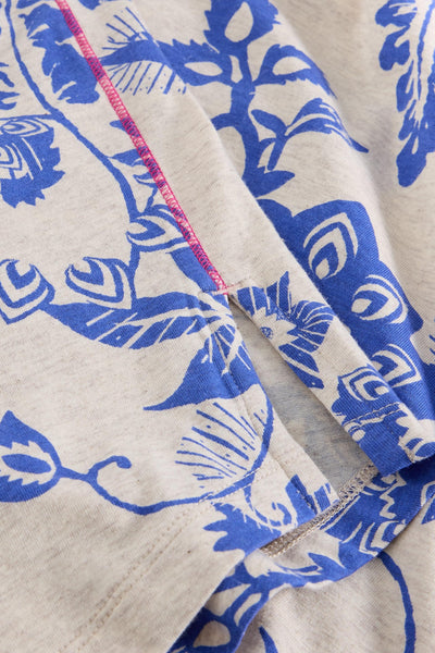 Close-up of blue floral patterned fabric with a beige background