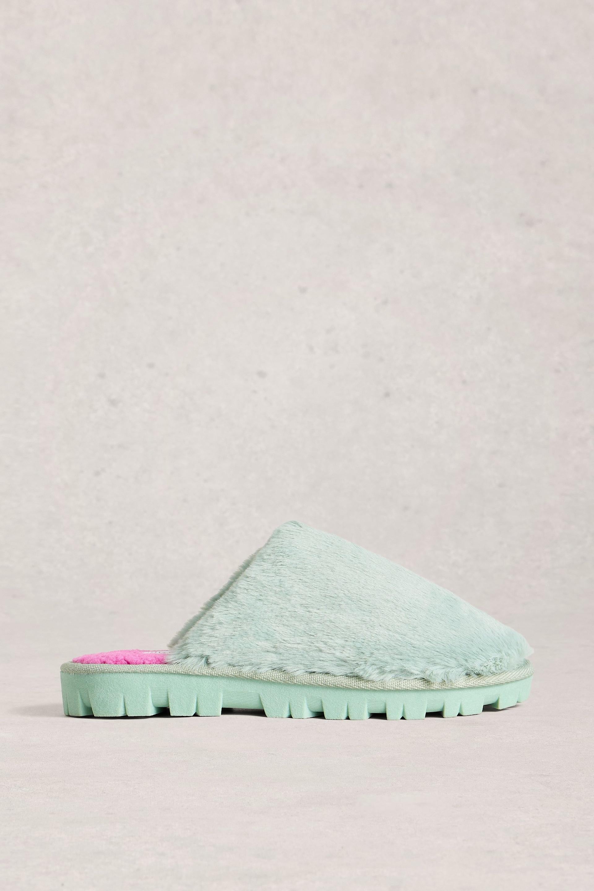 Mint green slipper with pink interior on a light gray background