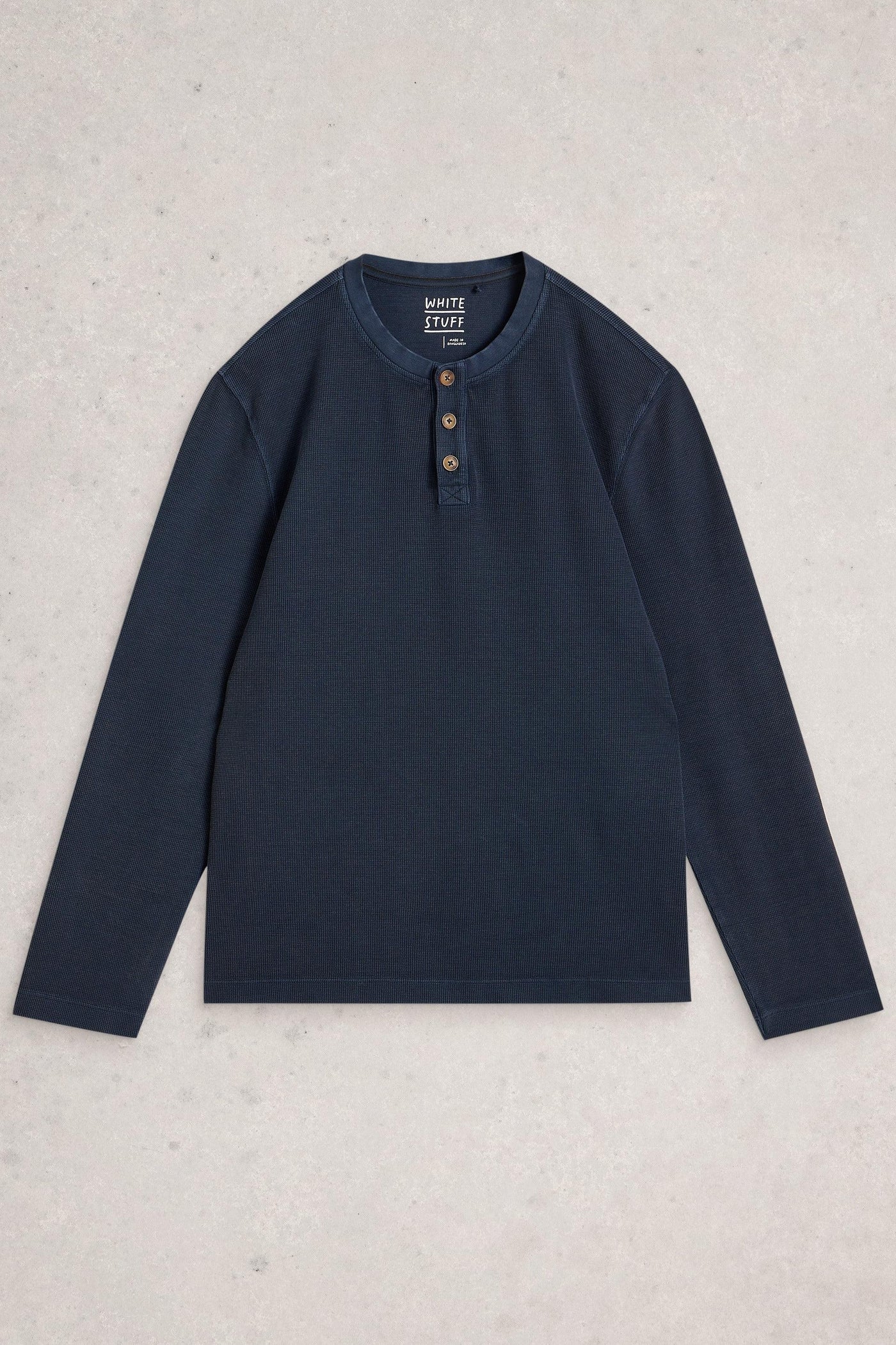 Navy long-sleeve shirt with buttons on a light gray background