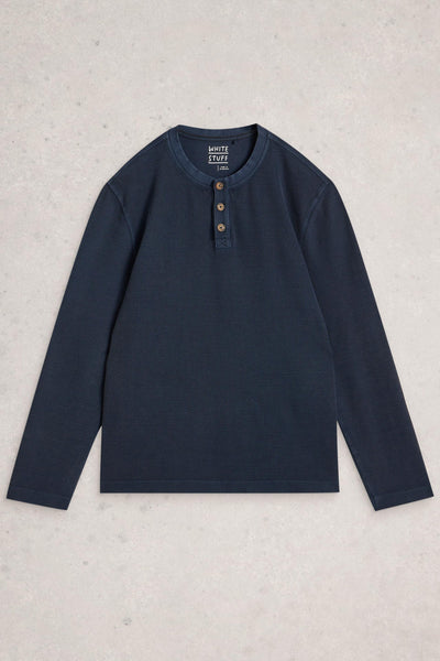 Navy long-sleeve shirt with buttons on a light gray background