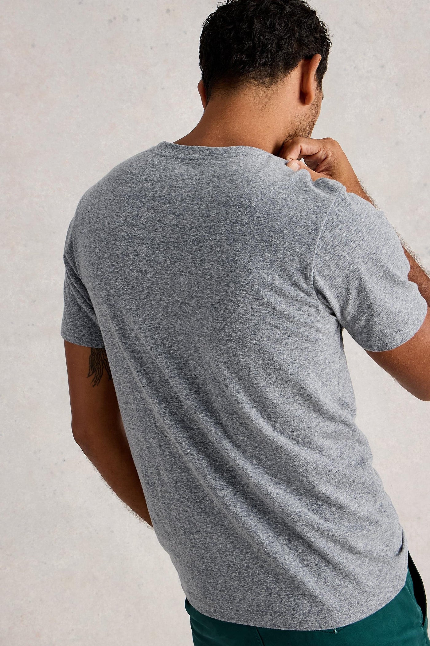 Back view of man wearing organic cotton grey t-shirt