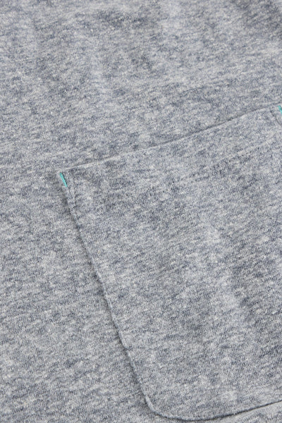 Close up of pocket on grey organic cotton t-shirt