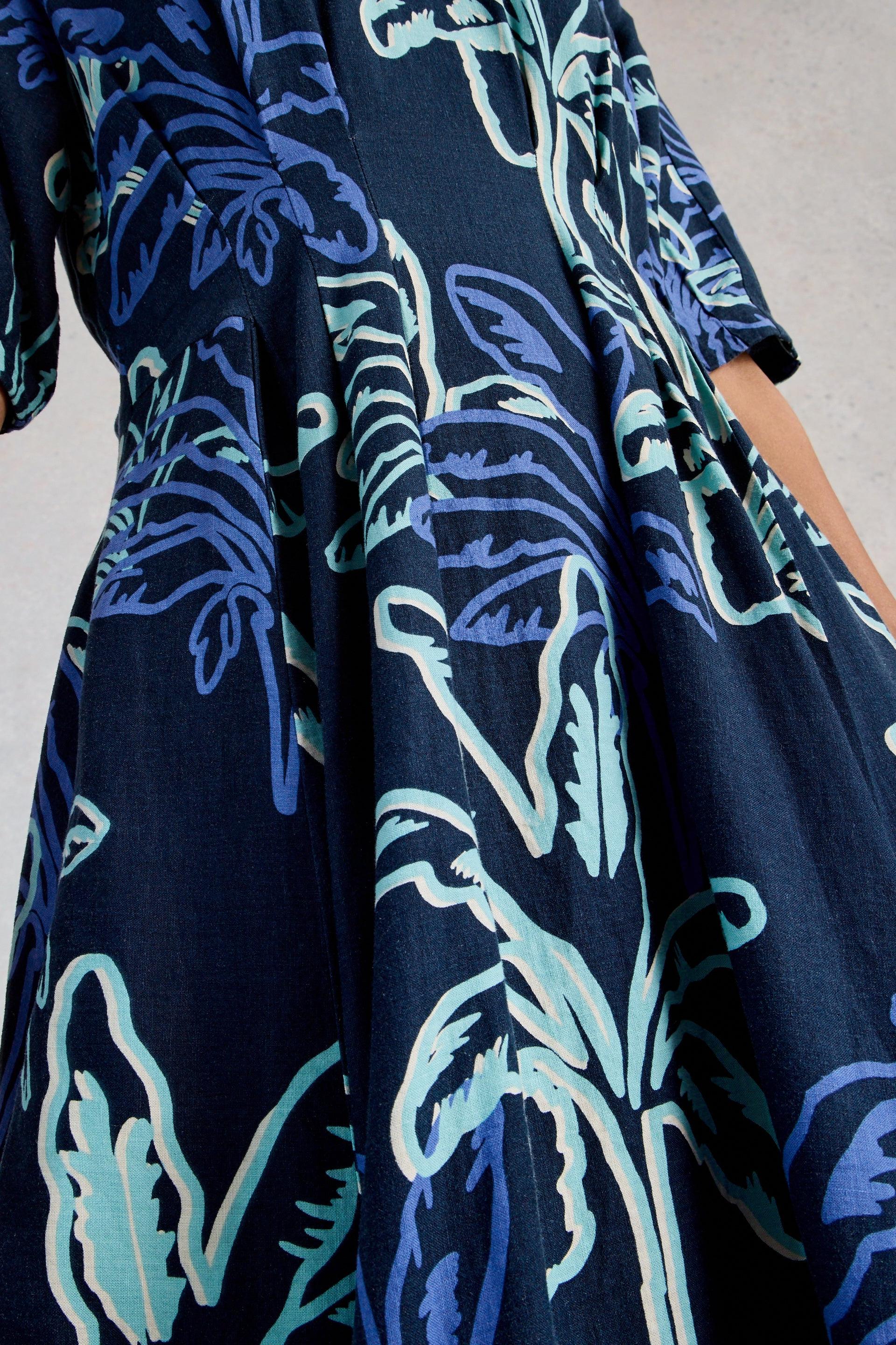 Navy blue dress with light blue floral pattern on a neutral background