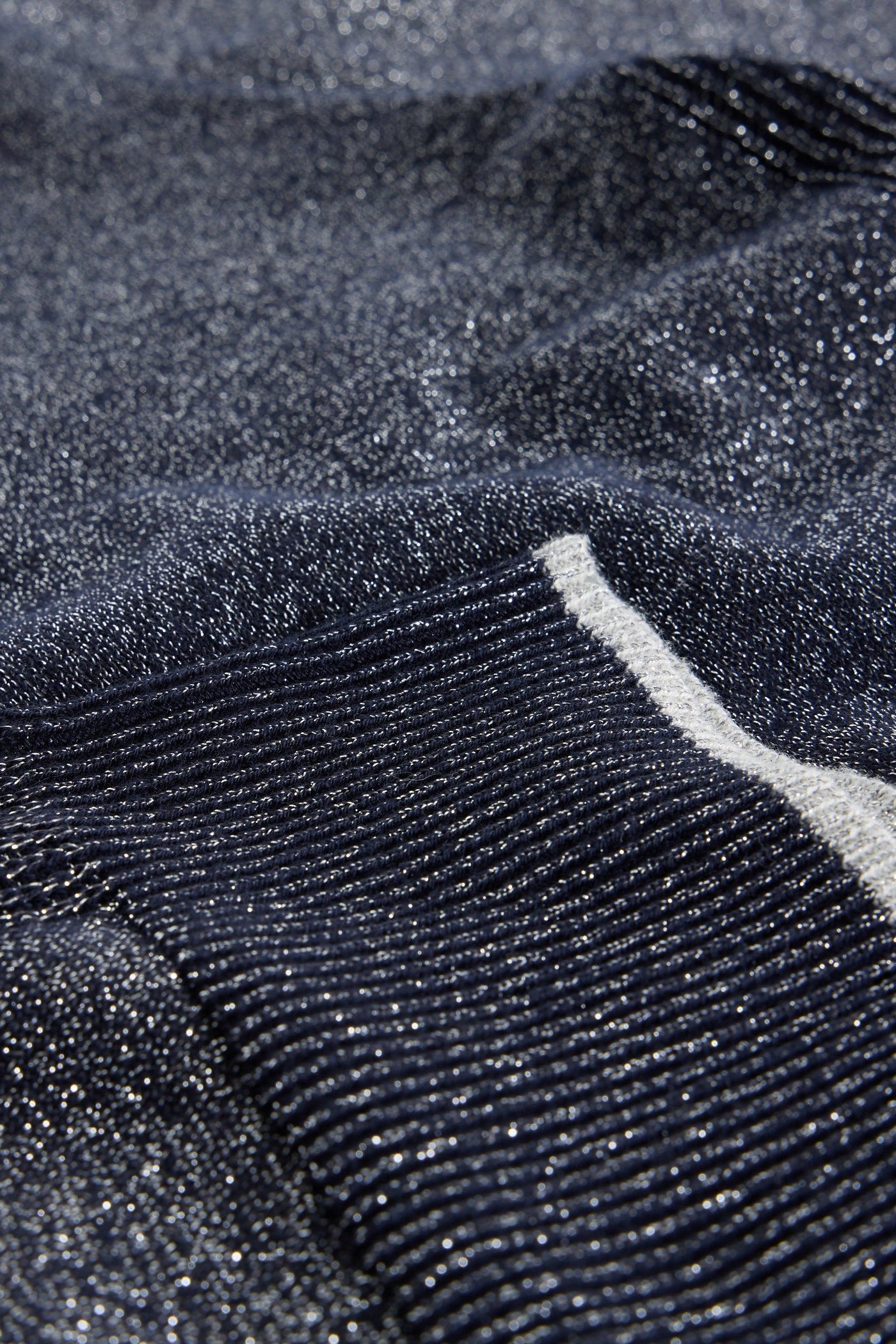 Close-up of textured dark grey fabric with a subtle pattern
