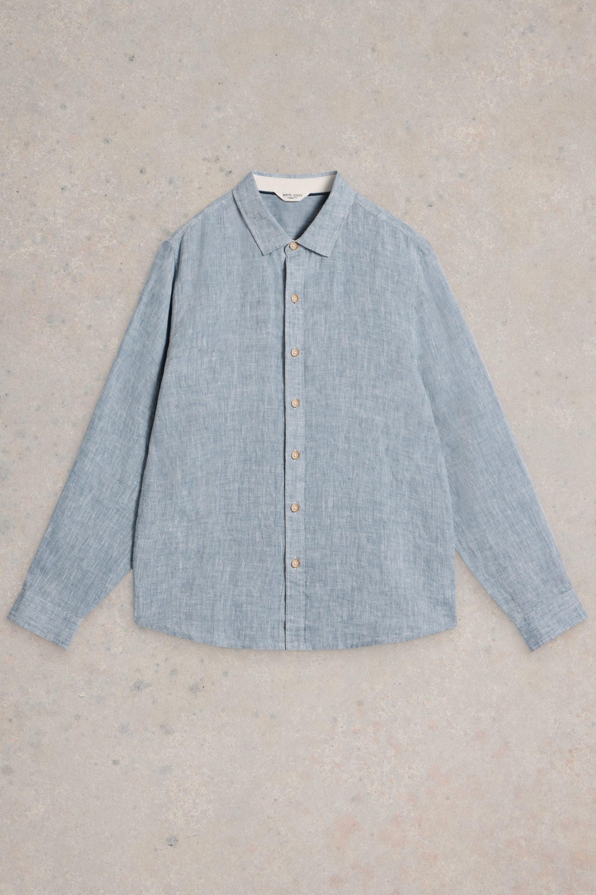 Light blue linen shirt on a textured beige background