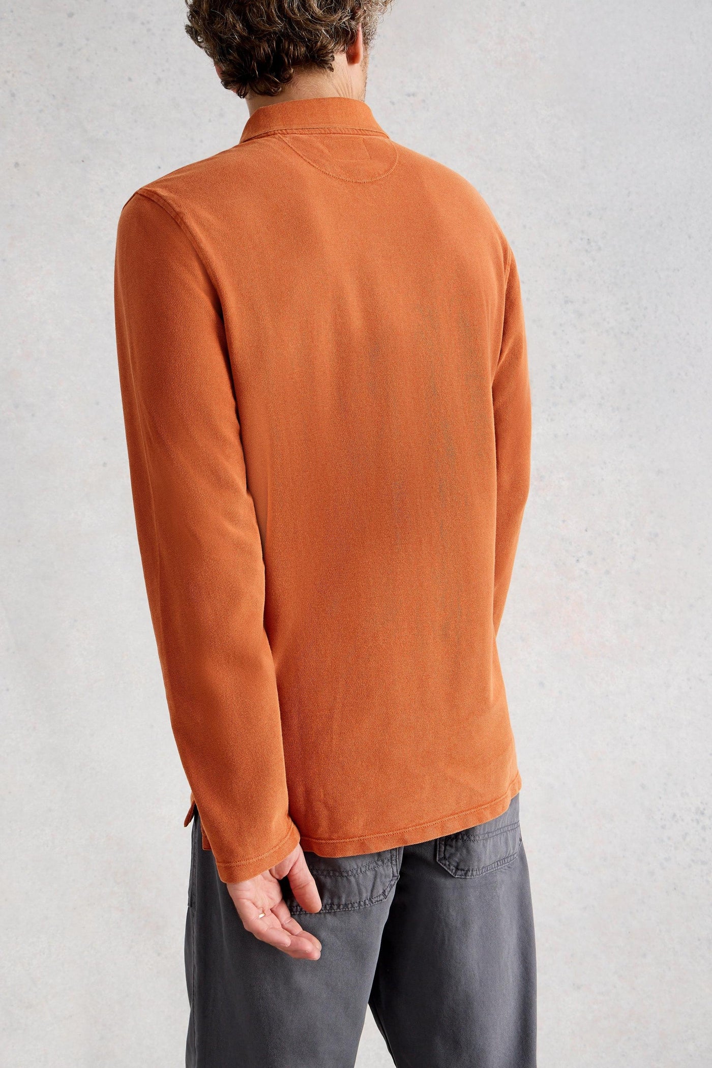 Back view of fairtrade cotton long sleeve orange polo 