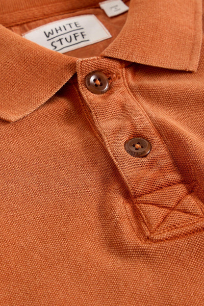 Close up of two button placket and collar on fairtrade cotton long sleeve orange polo 