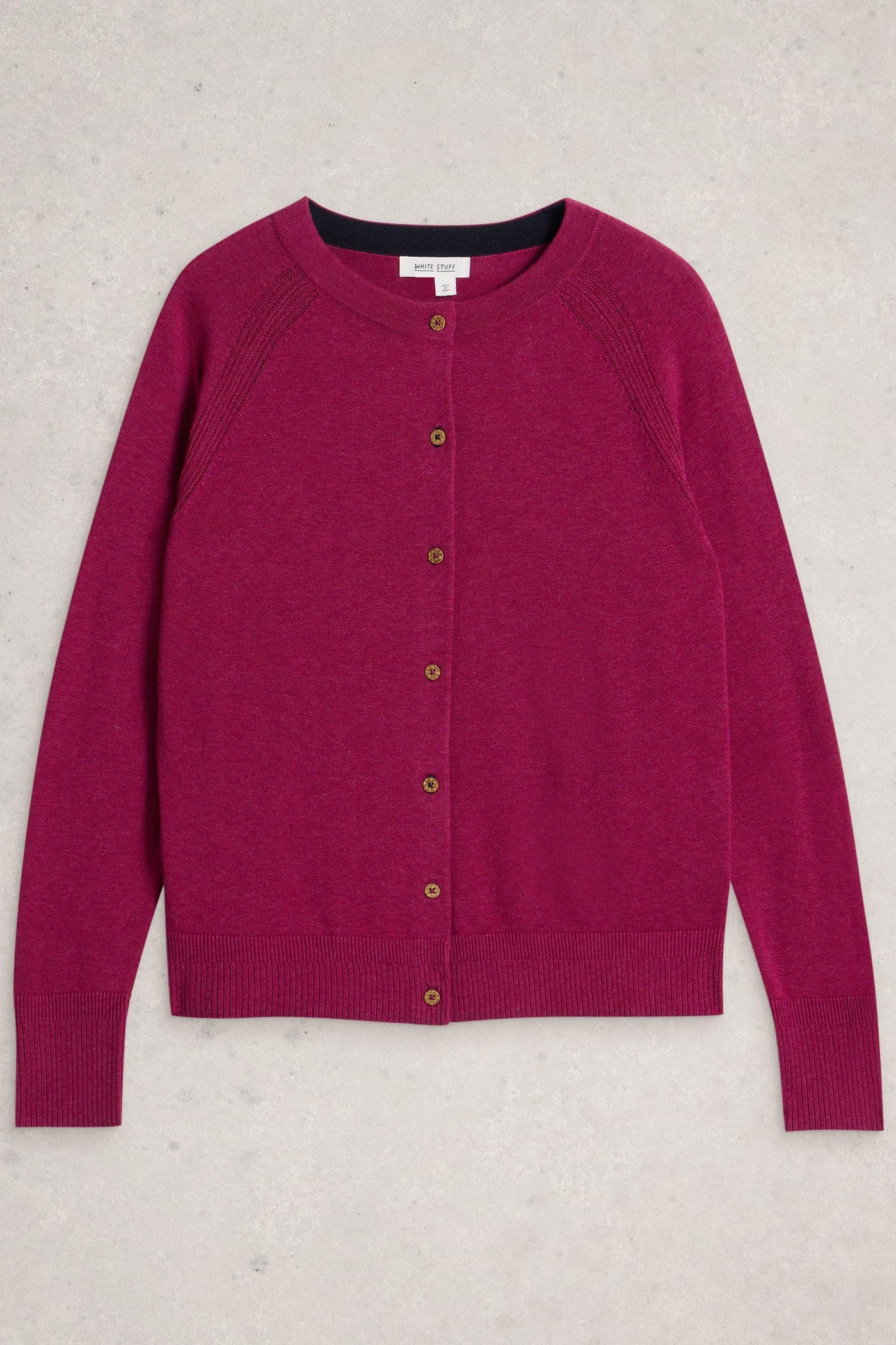 Organic cotton plum carding with button up closure laid flat on neutral background