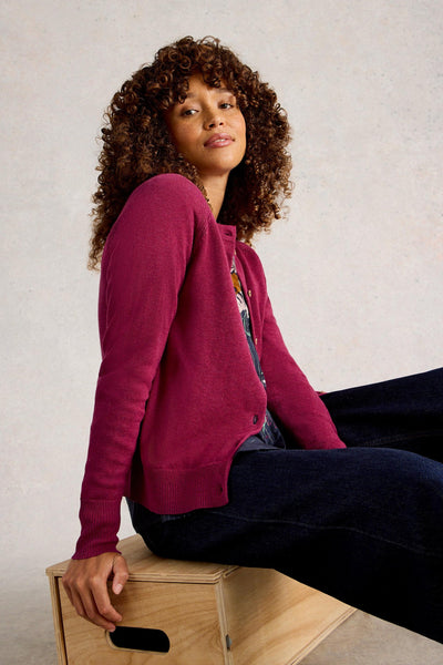 Model wearing organic cotton cardigan in plum colour, with crew neck and long sleeves