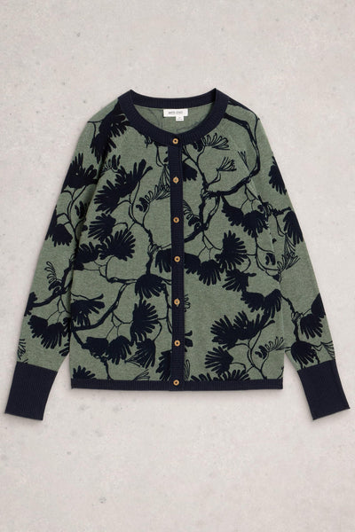 Flat lay of a green and navy floral cardigan with wooden buttons and navy ribbed cuffs and hem on a neutral background.