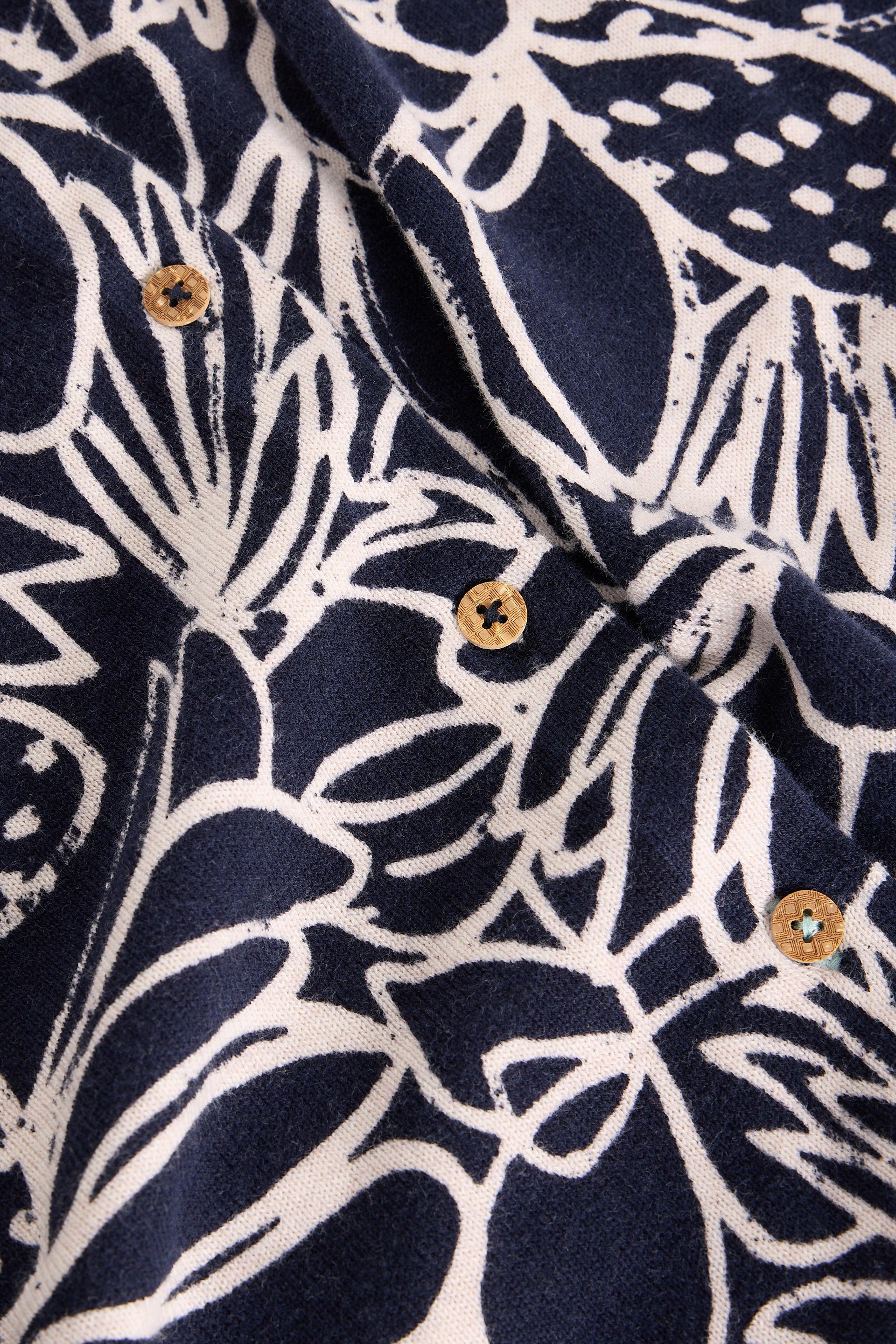 Navy blue fabric with white floral pattern and gold buttons