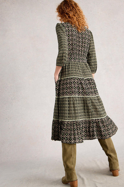 Back view of printed tiered midi dress with relaxed fit and tiered skirt styled with green boots