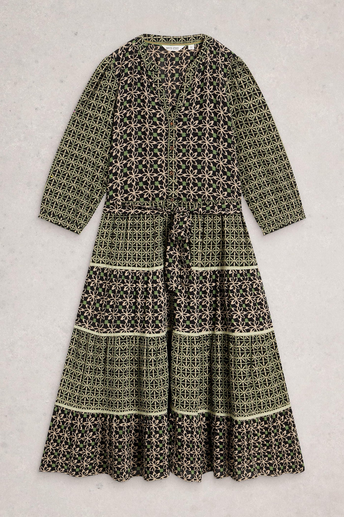 Tiered midi dress in folk-style print, folded flat to show notch neck, tie waist and relaxed shape