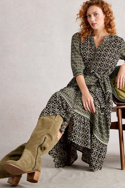 Woman sitting down wearing printed tiered midi dress in Lenzing Ecovero viscose with notch neck and 3/4 sleeves