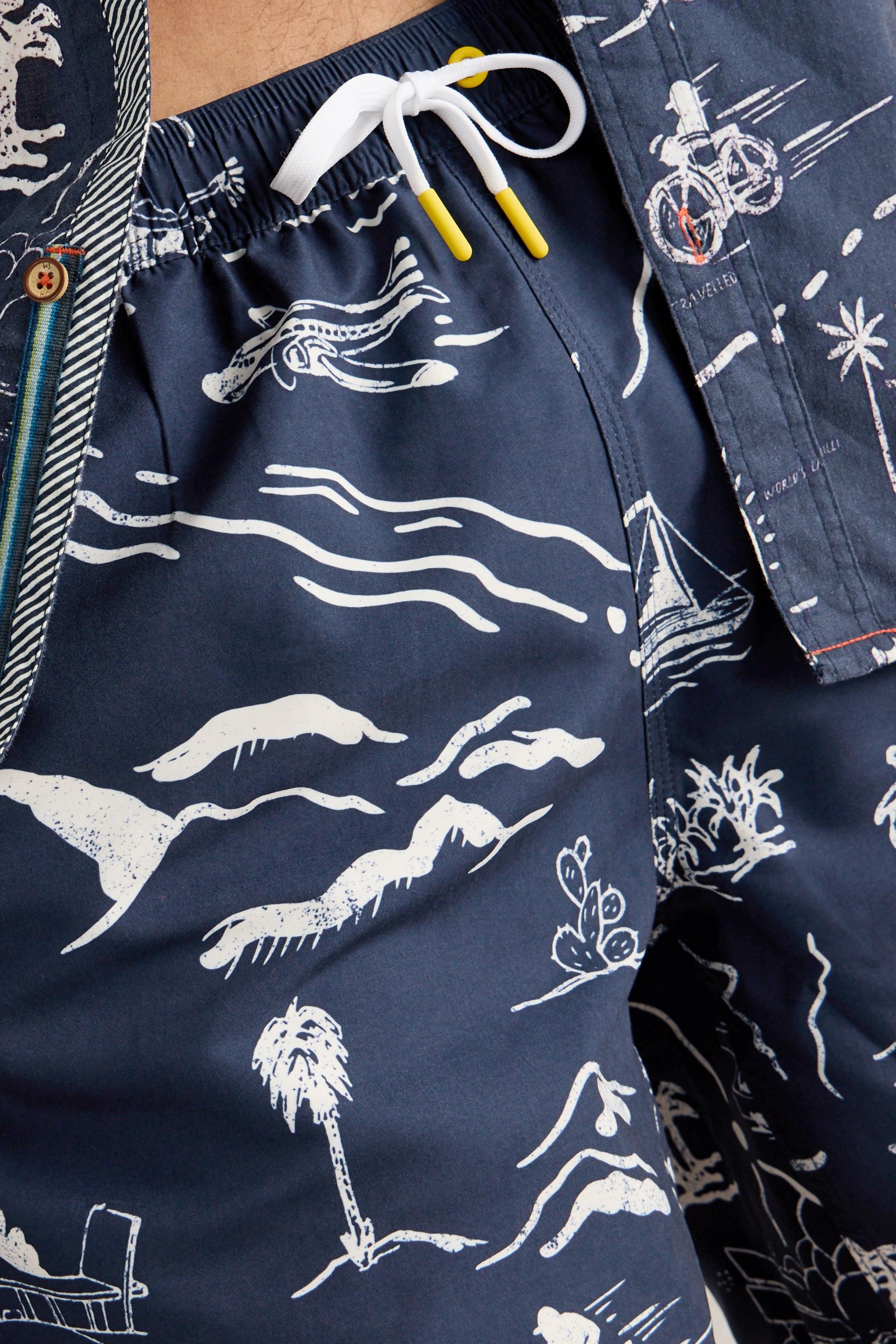 Close up of white and yellow drawstring and map tropical print.