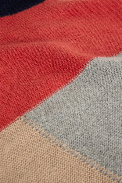 Close-up of a wool fabric with red, gray, and beige colors.