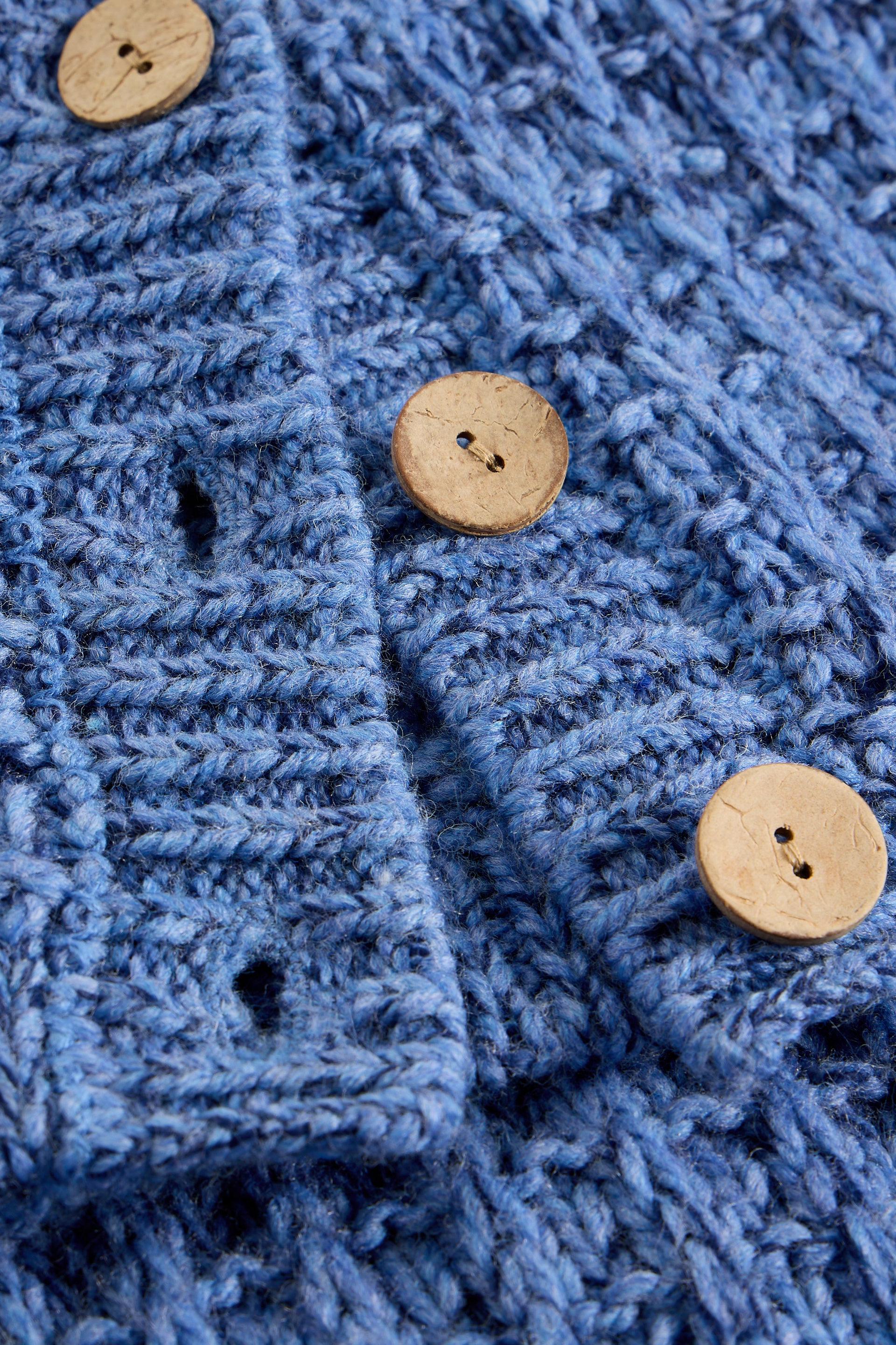 Close-up of a blue textured fabric with wooden buttons