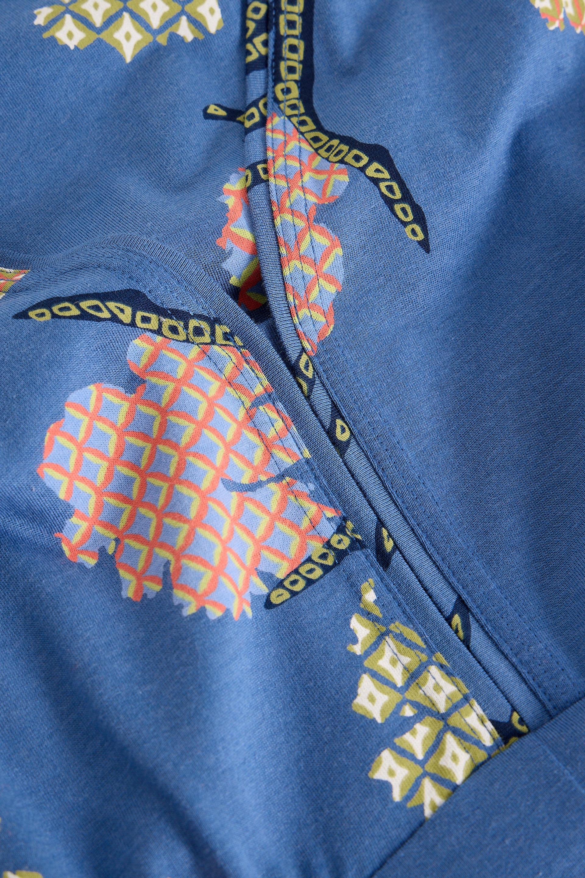 Close-up of a blue dress with colorful geometric patterns