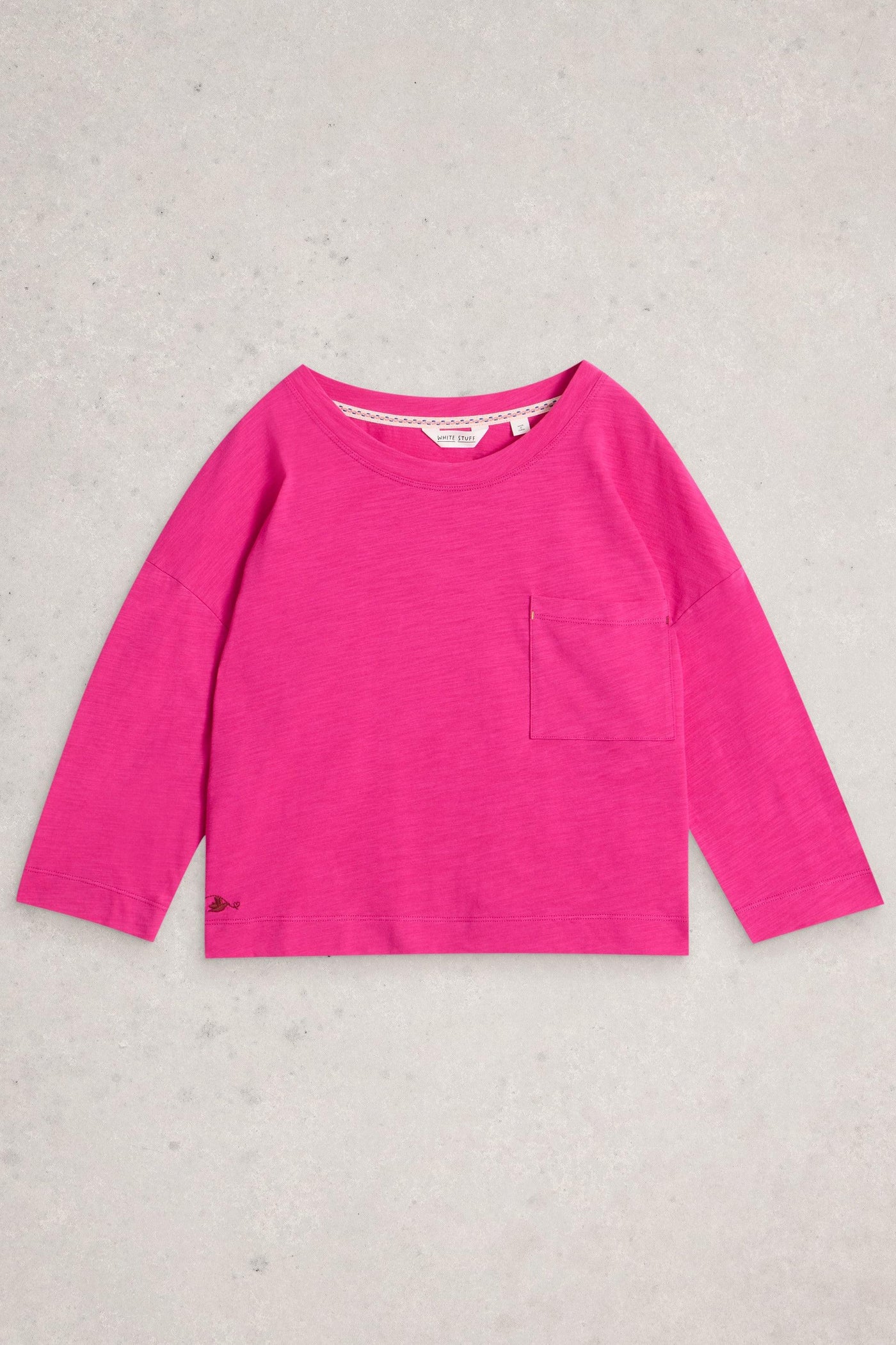Pink long-sleeve shirt on a light gray background