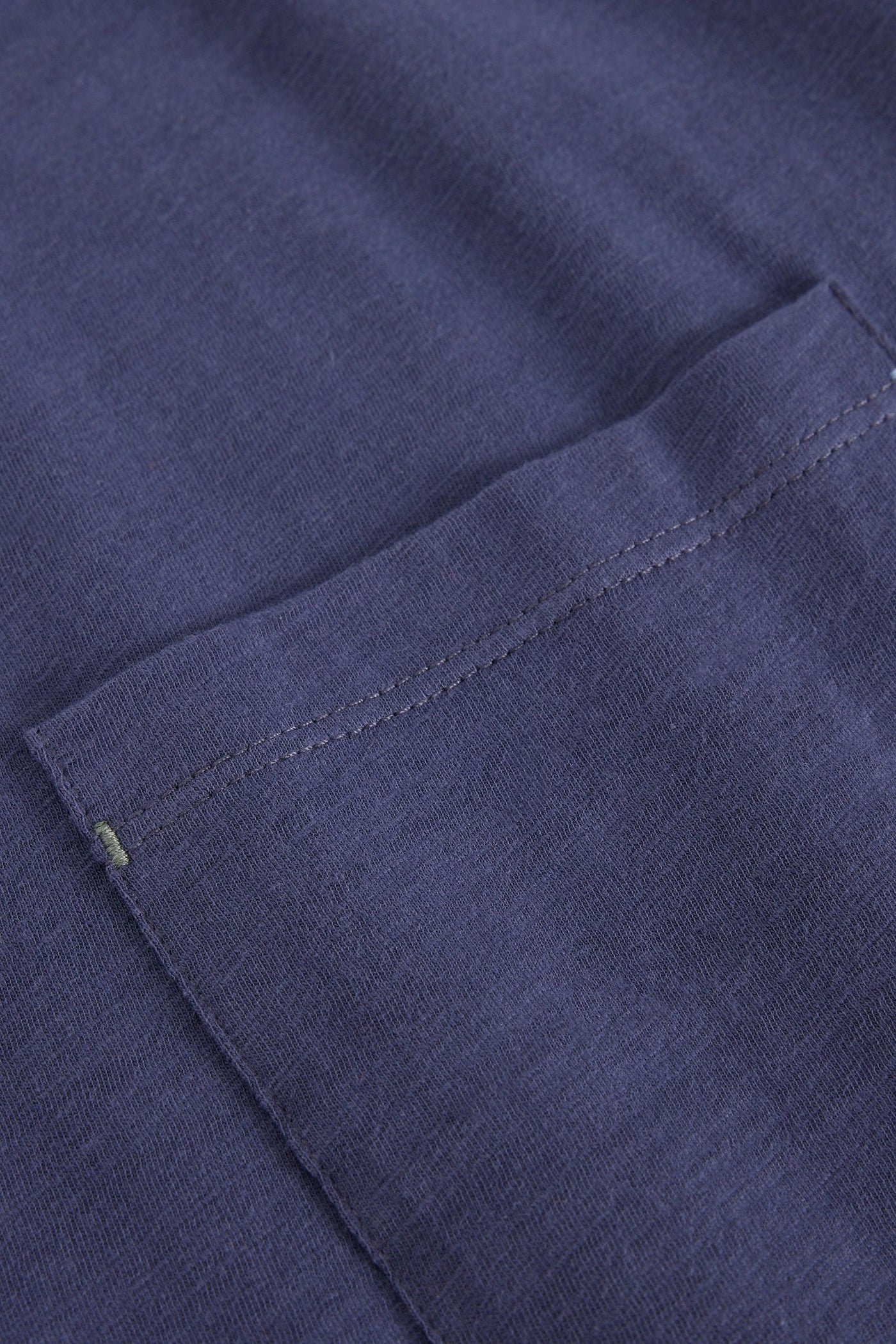 Close-up of a purple organic cotton texture with stitching detail