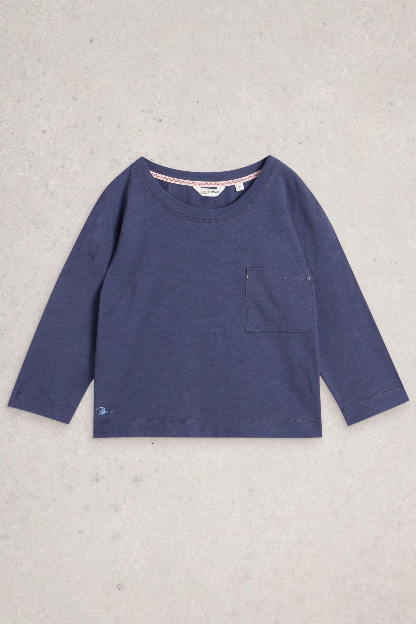 Purple long-sleeve shirt on a light gray background