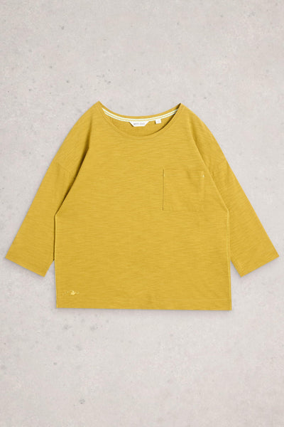 Yellow long-sleeve shirt with a pocket on a light gray background