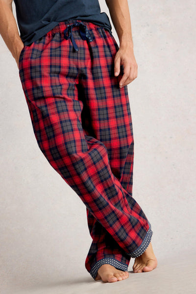 Organic cotton plaid pajama pants worn by a person on a neutral background