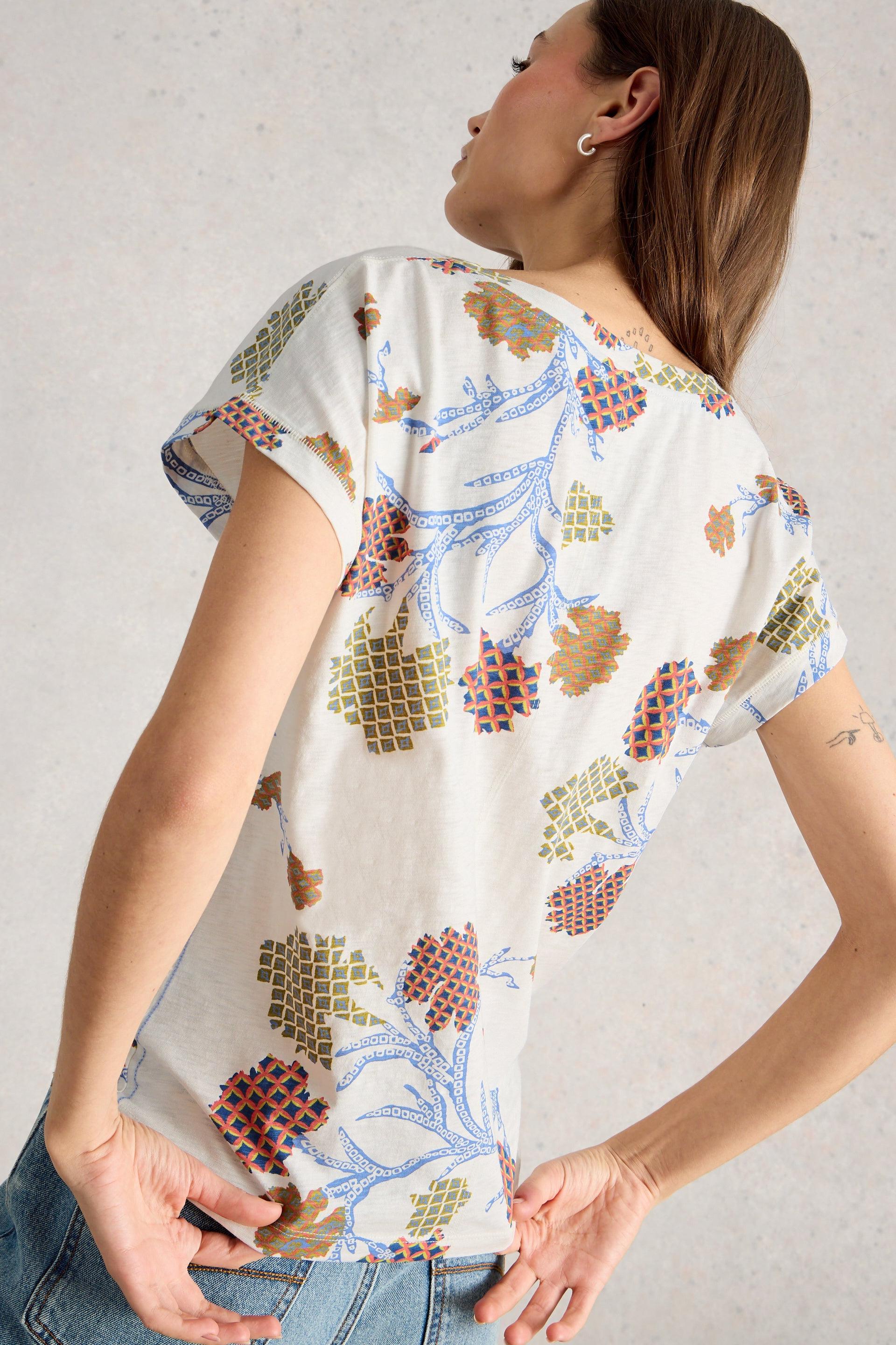 Woman wearing a patterned cotton t-shirt with a neutral background