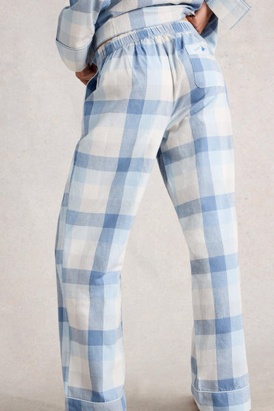 Blue and white checkered pants worn by a person on a plain background