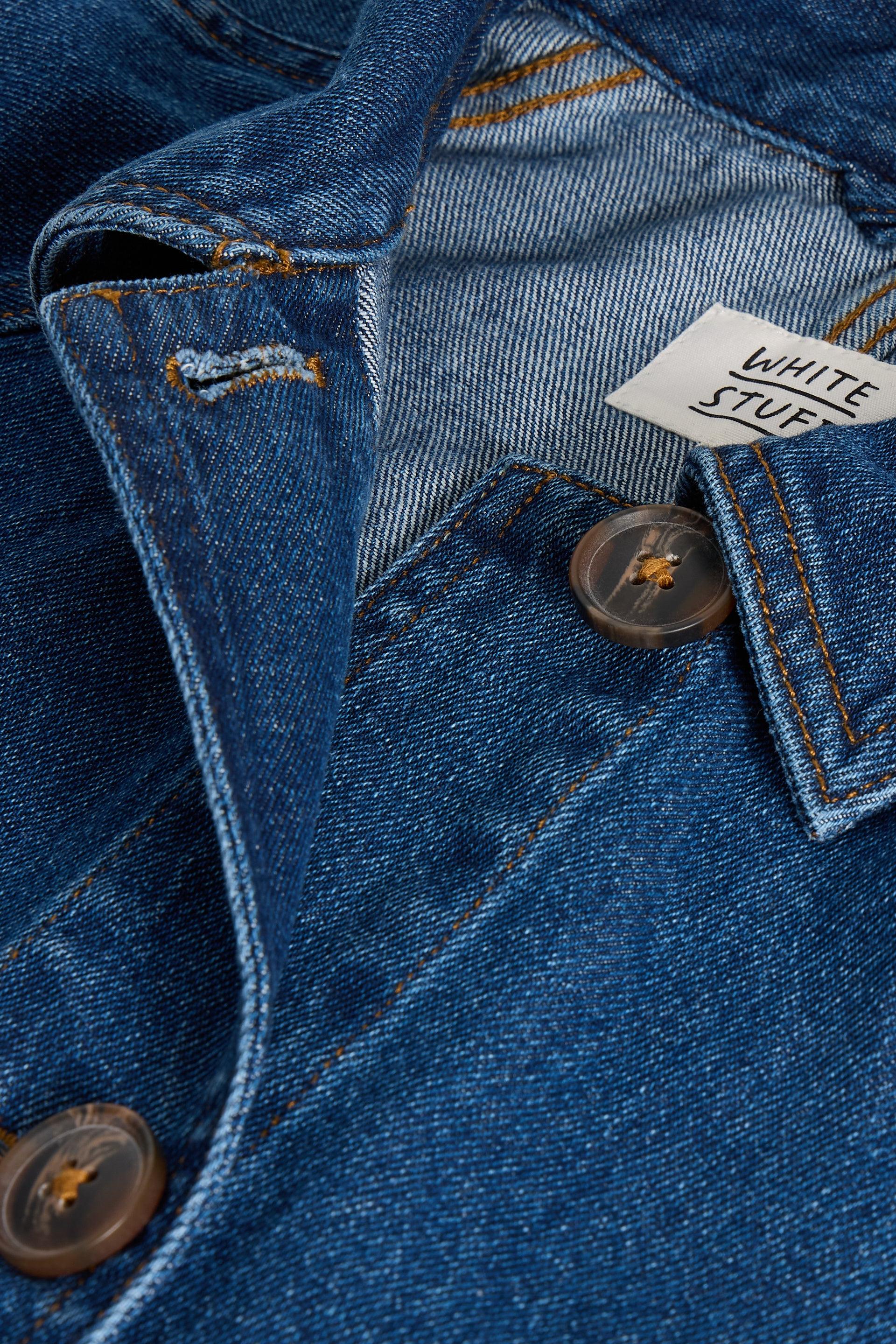 Close-up of a blue denim jacket with a brand label.