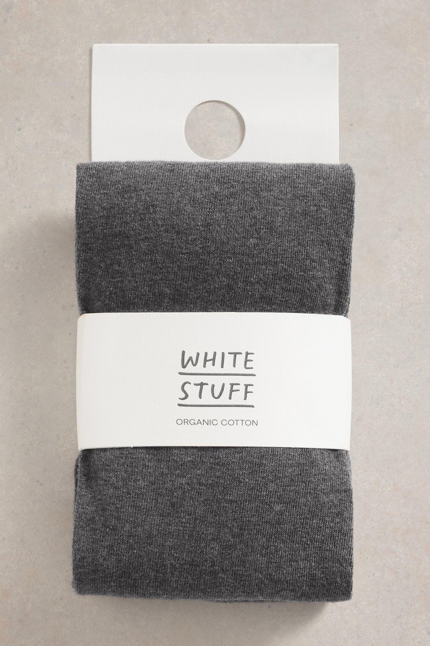 Pack of gray tights with 'White Stuff' label on a beige background