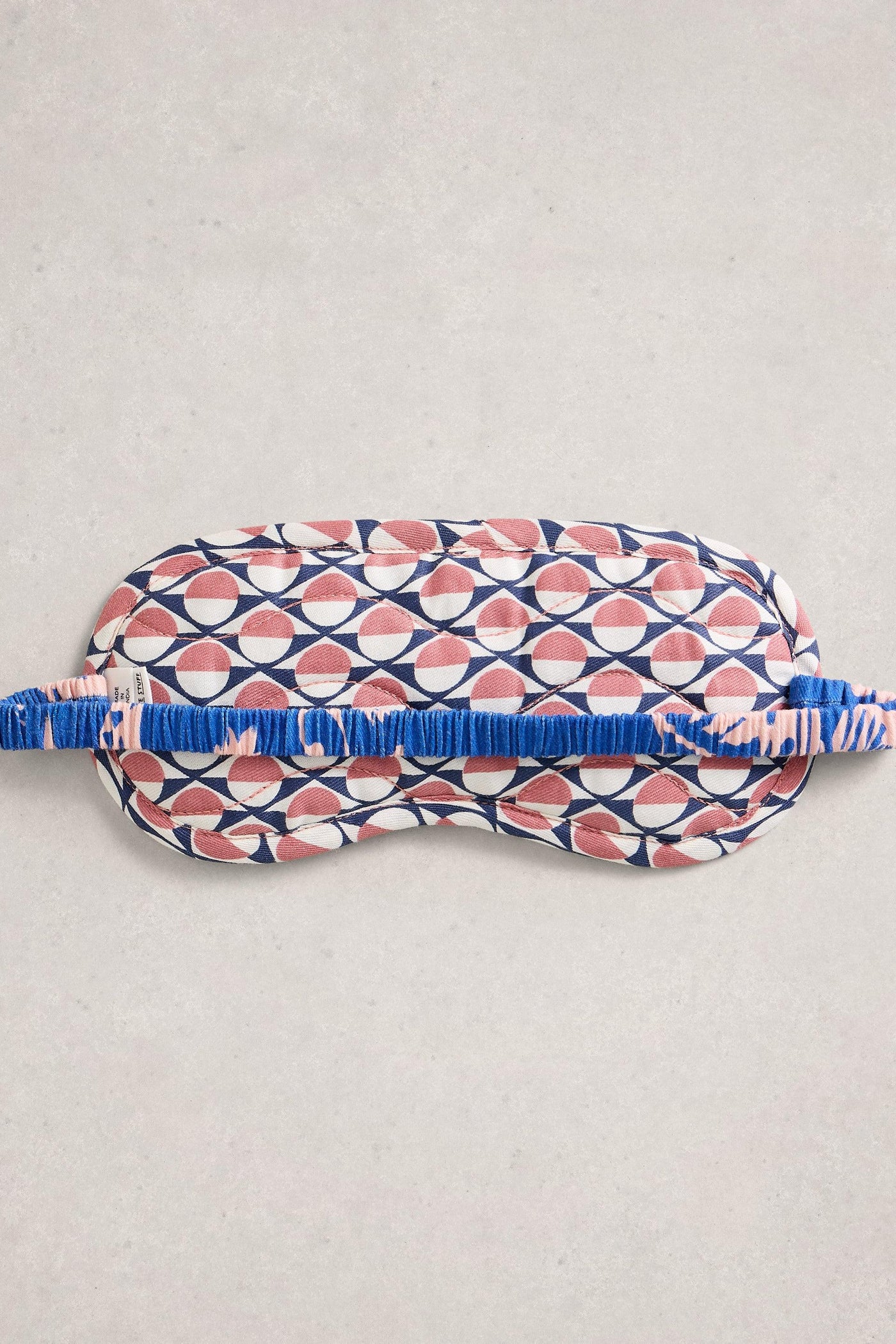 Organic cotton sleep mask with geometric pattern on a light gray background