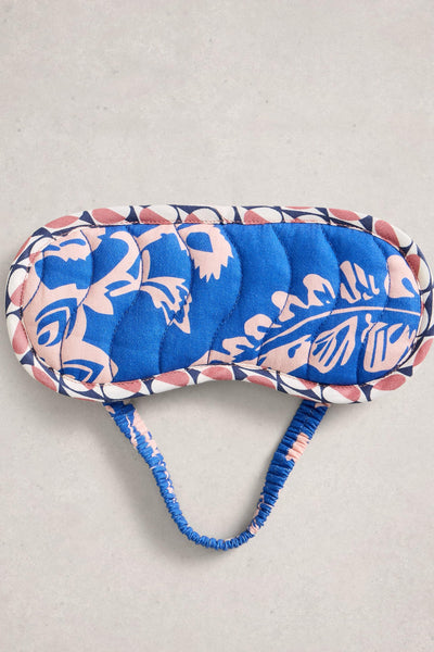 Blue and pink patterned eye mask on a light gray background