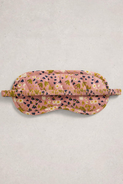 Floral patterned sleep mask on a light gray background
