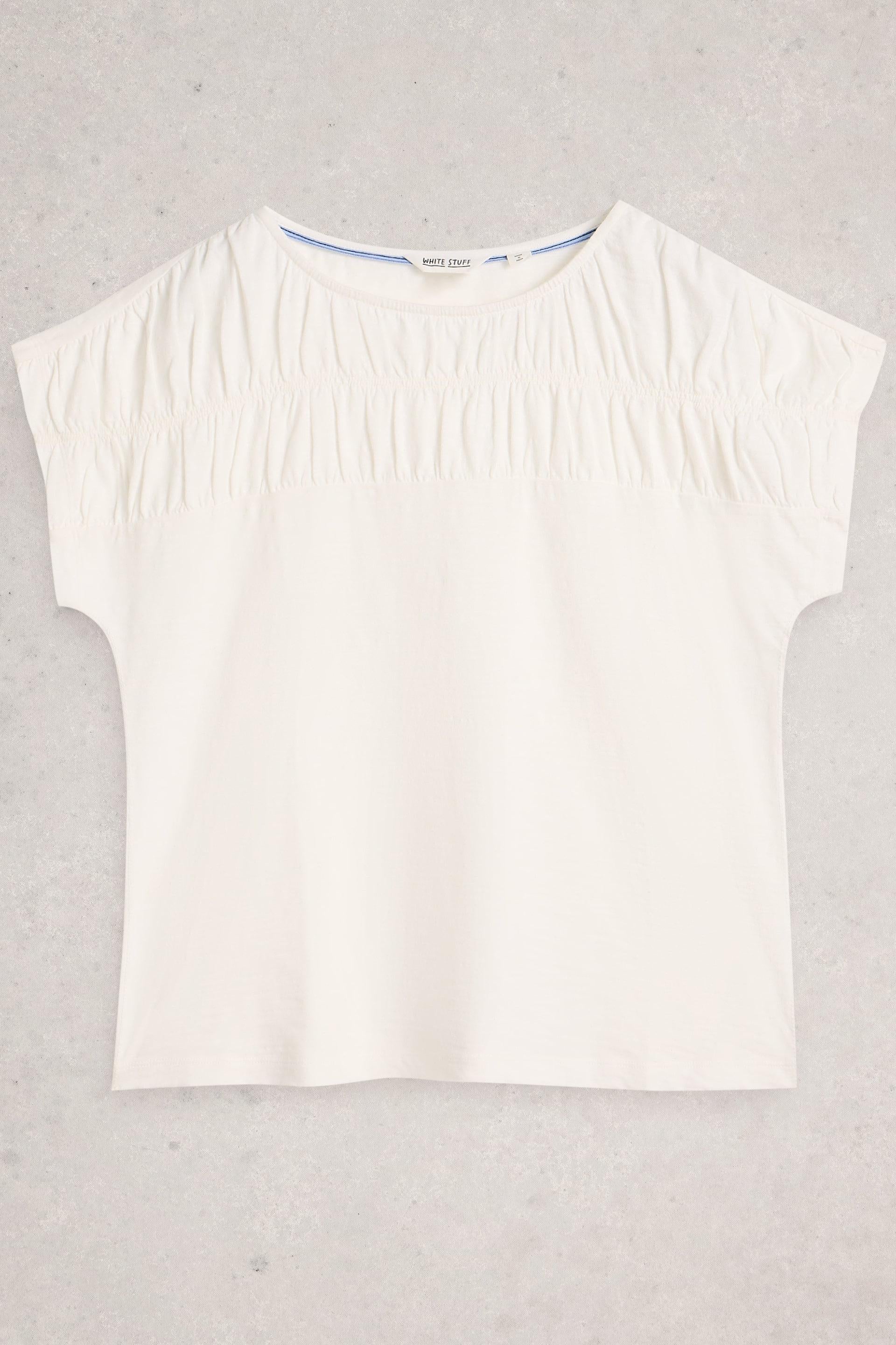 White sleeveless top on a light gray background