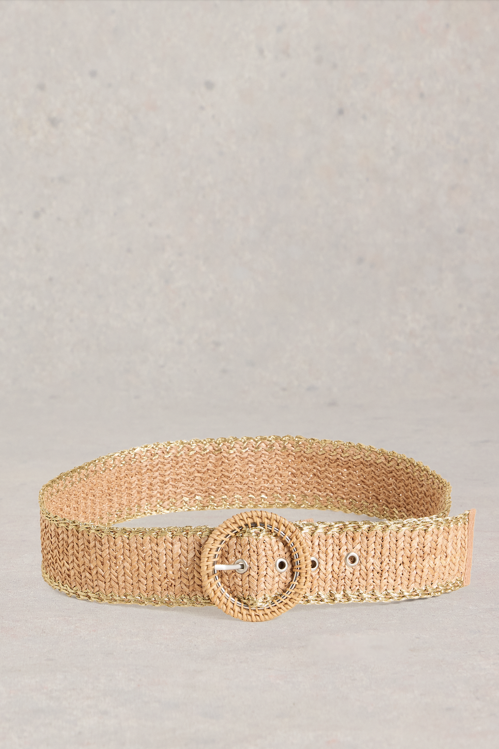 Brown raffia belt on a grey background.