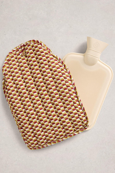 Hot water bottle with a patterned cover on a light gray background