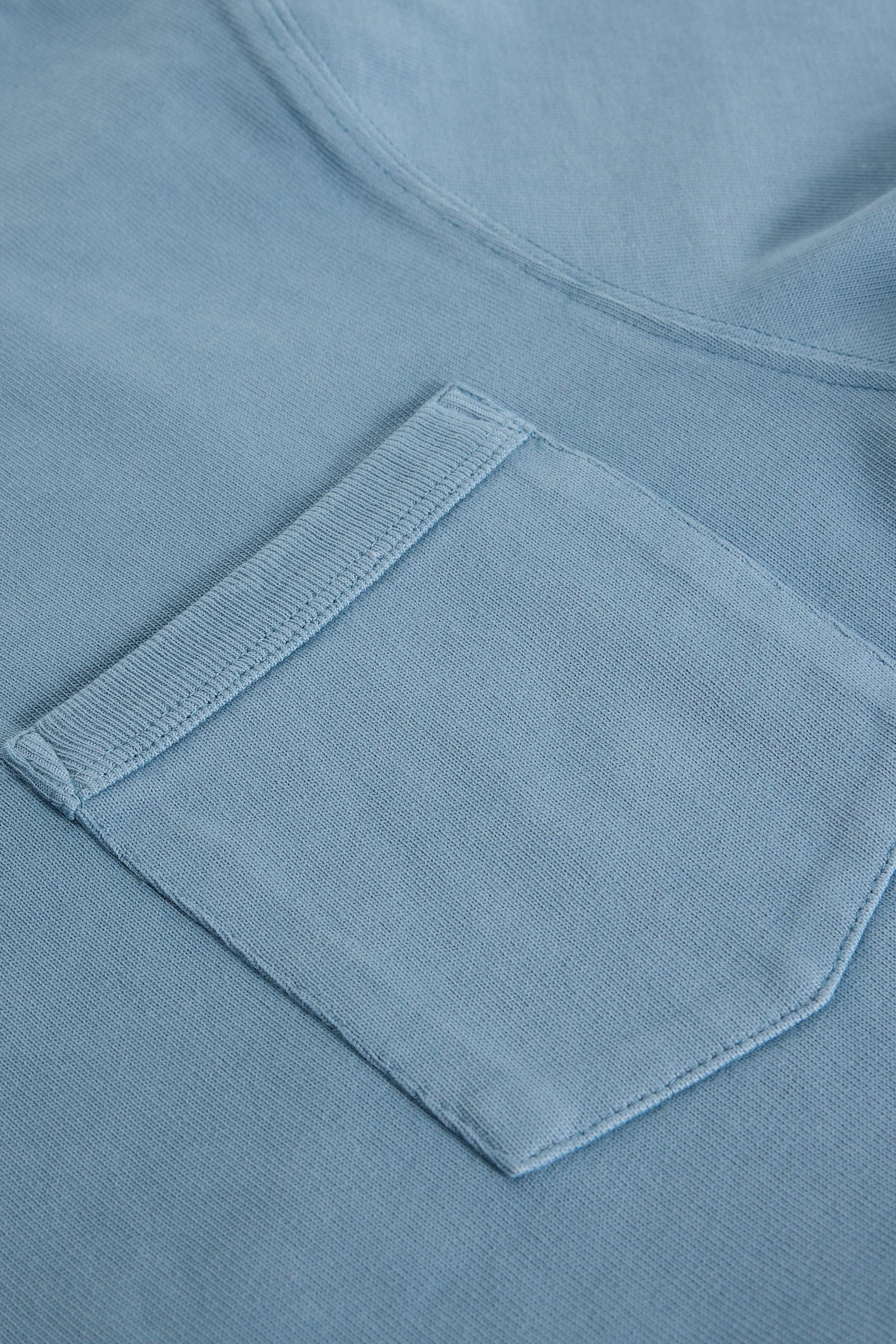 Close-up of a blue pocket on organic cotton shirt