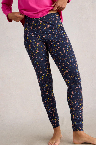 Navy organic cotton leggings with colourful star pattern worn by a person on a plain background