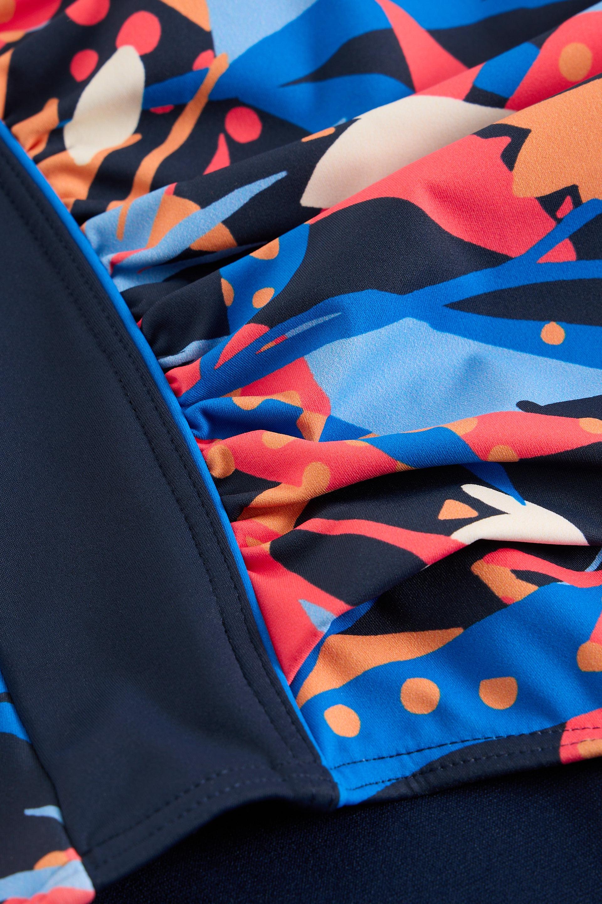Close-up of a colorful patterned fabric with abstract designs.
