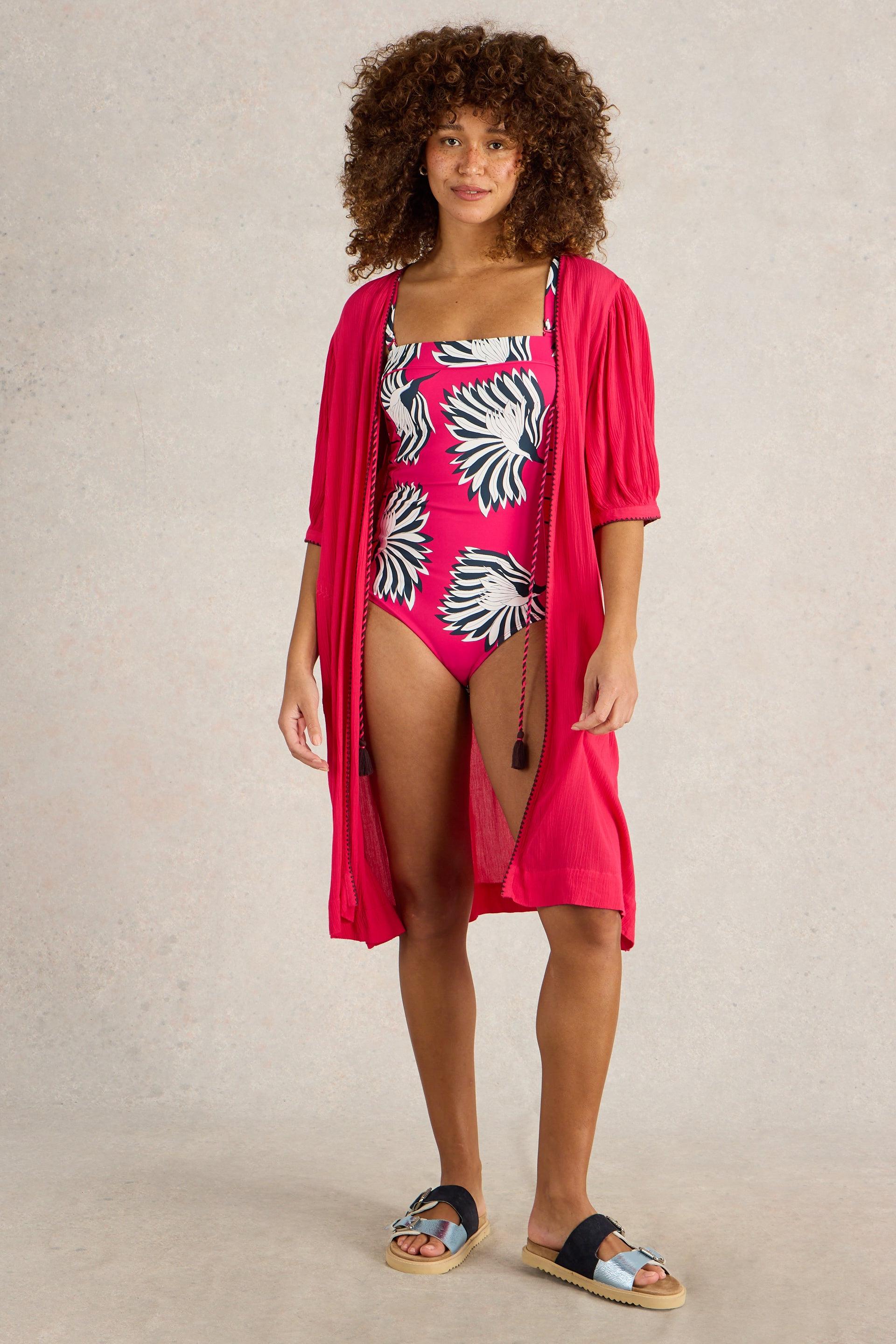 Model wearing the pink Suki Swimsuit, accessorised with a pink kimono.