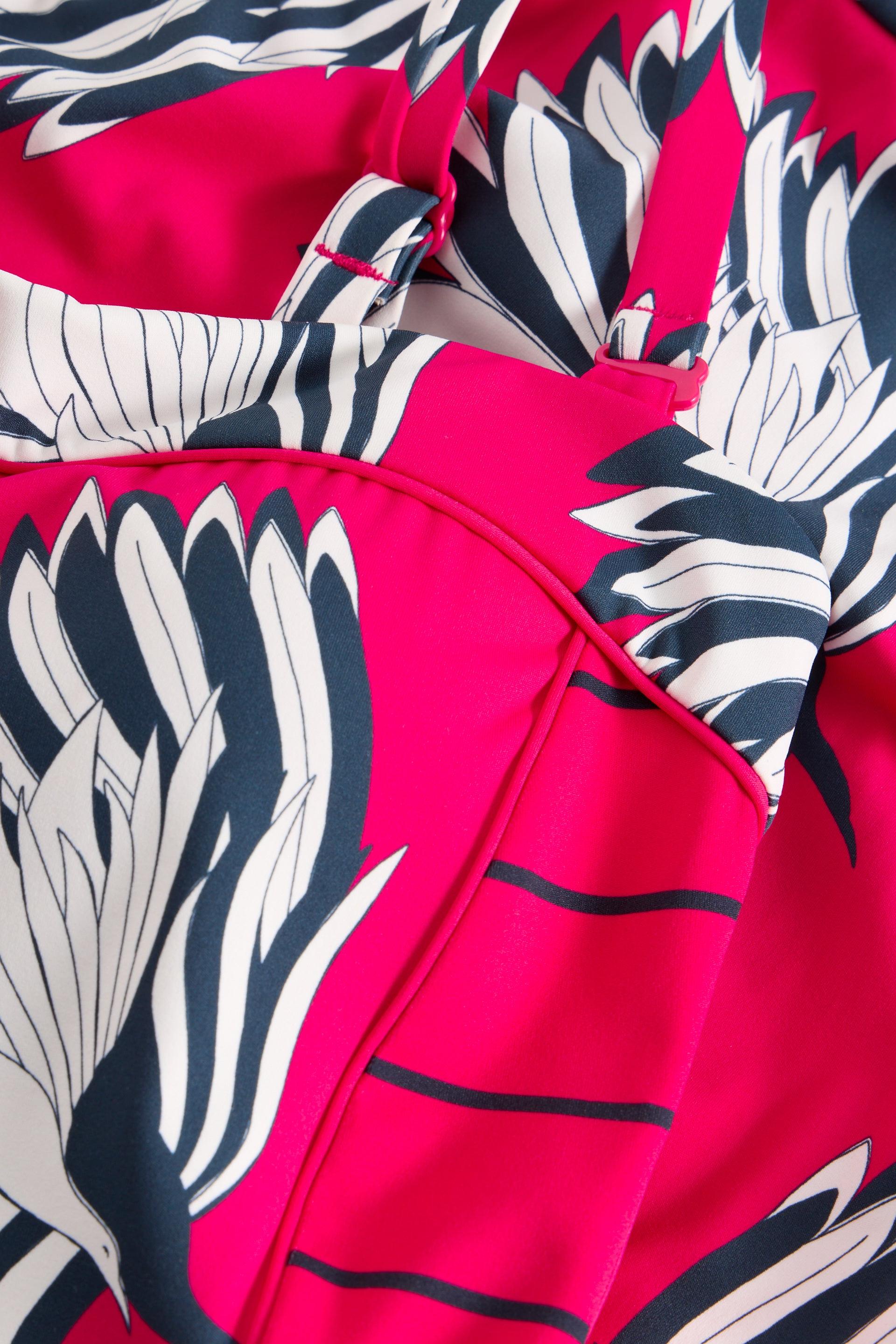 Close-up of the Suki Swimsuit fabric showing the large-scale floral pattern and ruching detail.